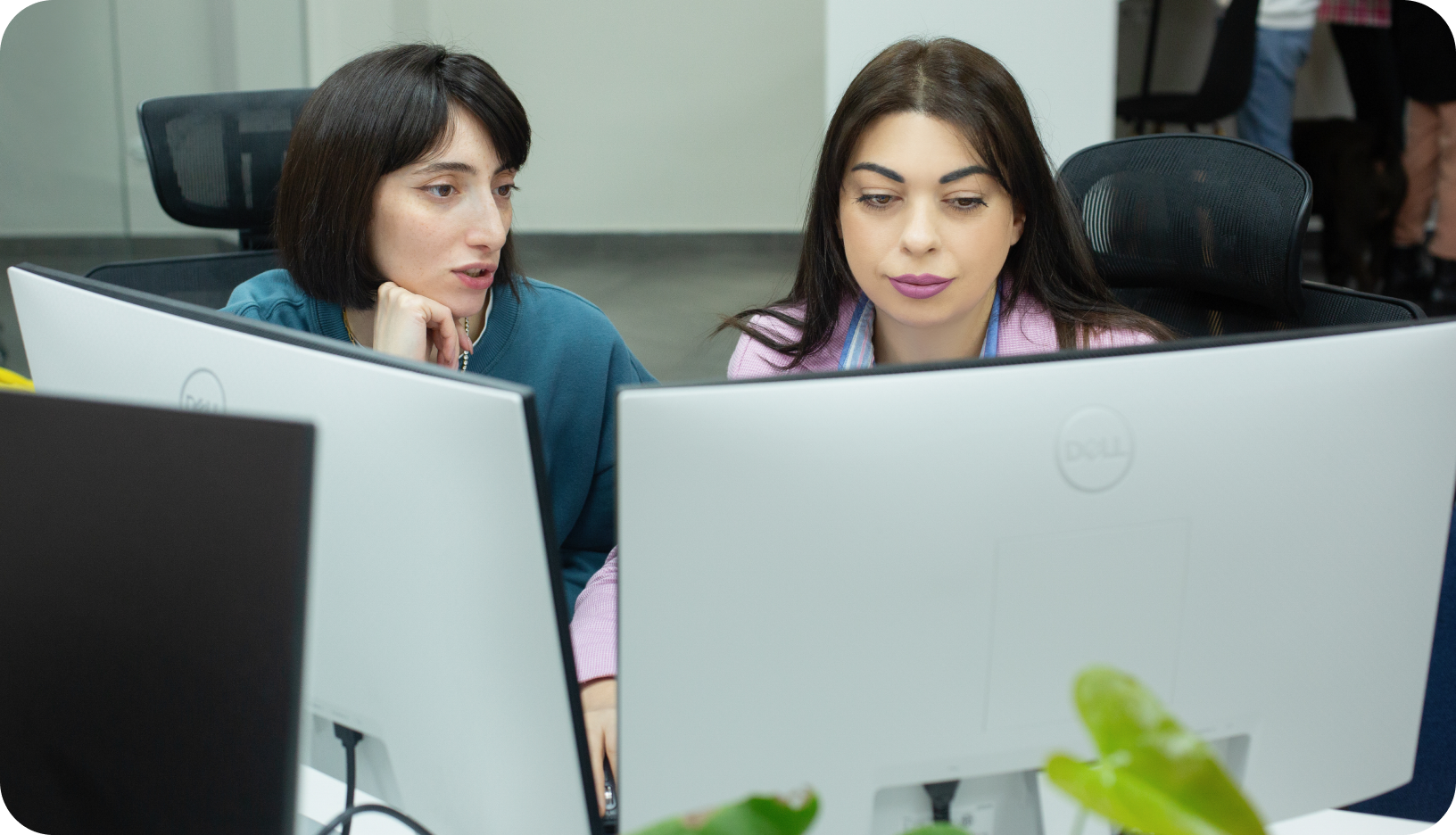 Photo of team discussing work.